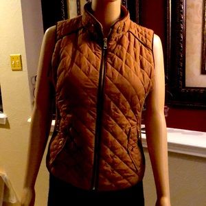Beautiful tan vest with brown trim very sliming worn once.